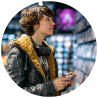 woman shopping for a new video game in a gaming store
