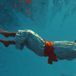 man floating laying down wearing gaming headphones